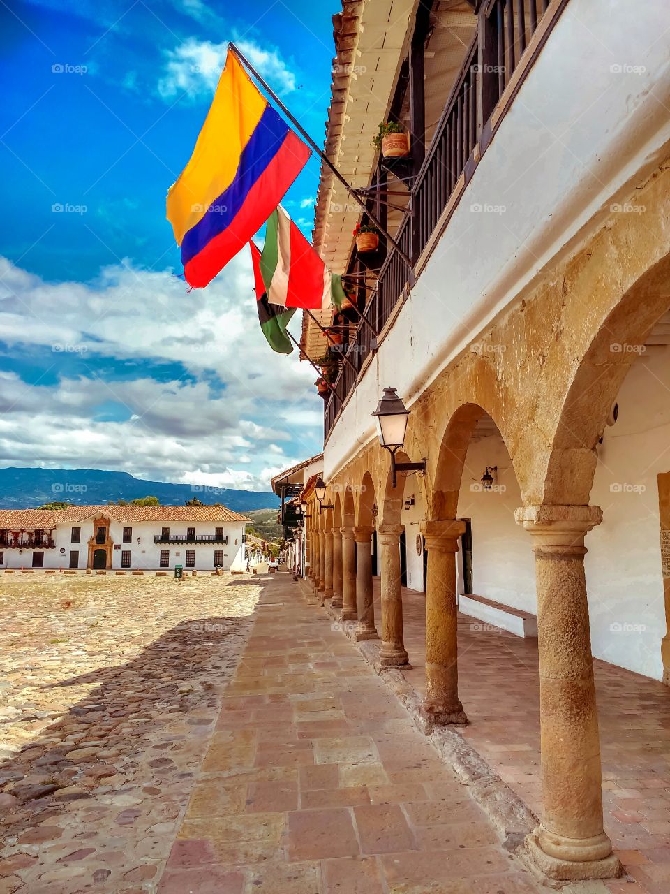 Colombian flag flies in the main square of Villa de Leyva, Boyacá, Colombia. Bandera de Colombia ondea en la plaza principal de Villa de Leyva, Boyacá, Colombia.