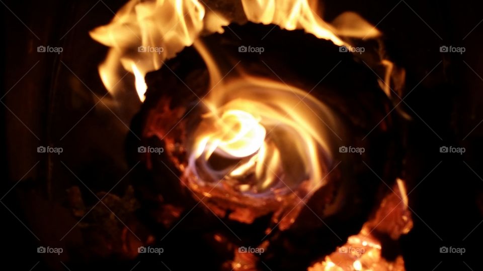 fire circle. Hollow log burns