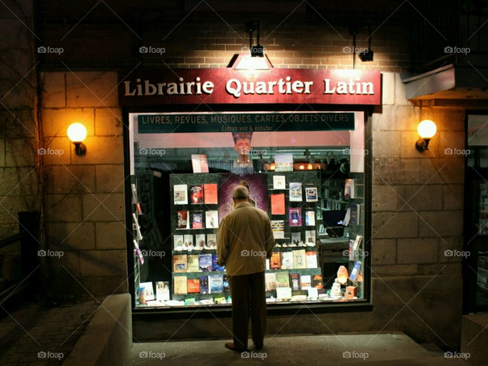 Old man looking at a bookstore