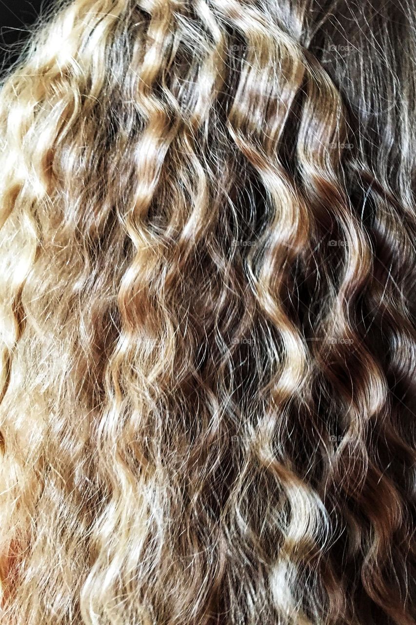 Curly blonde hair