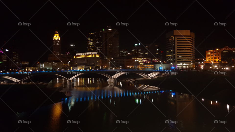 The city at night as it reflects the water