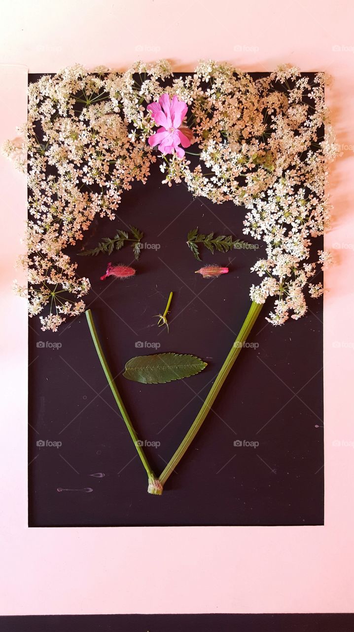 Face made with flower and twig