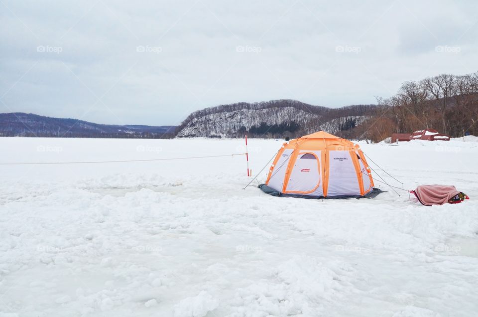 Orange Tent In the Middle of Frozen Lake Abashiri