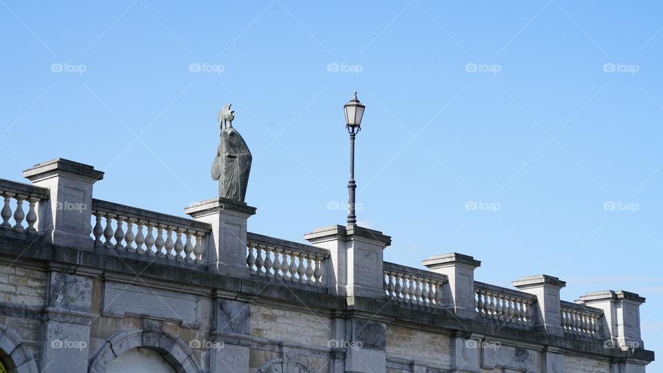 Sculpture and lamp post on an old stone bridge in Antwerp.