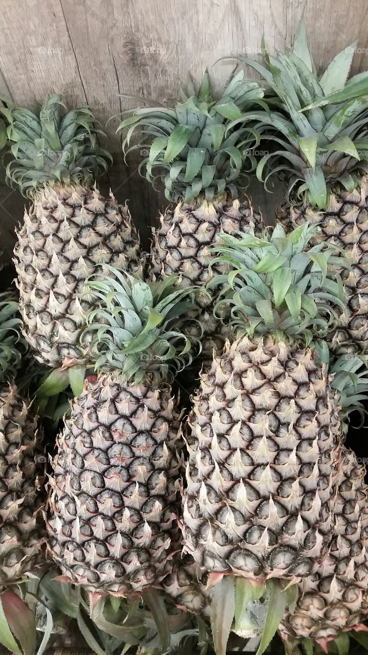 tropical fruit. pineapples sold in the market place