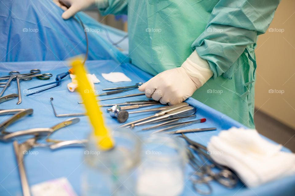working table with sterilized instruments of a practicing surgeon during surgery