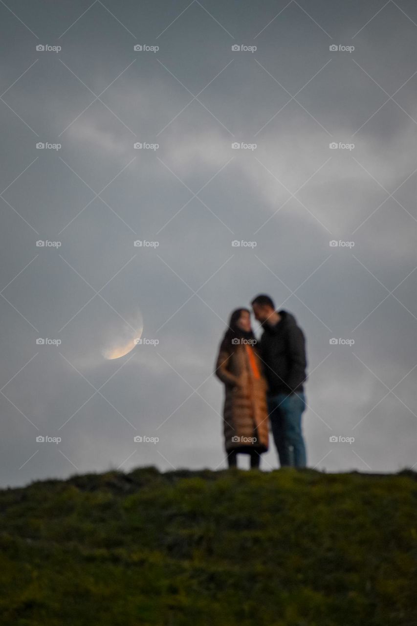 a couple and moon