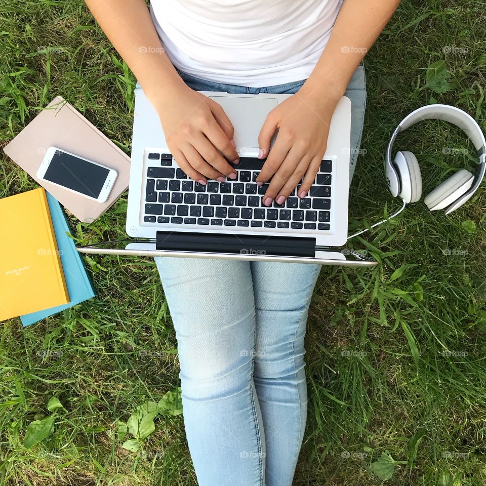 Girl with laptop and smartphone on the park. Outdoor