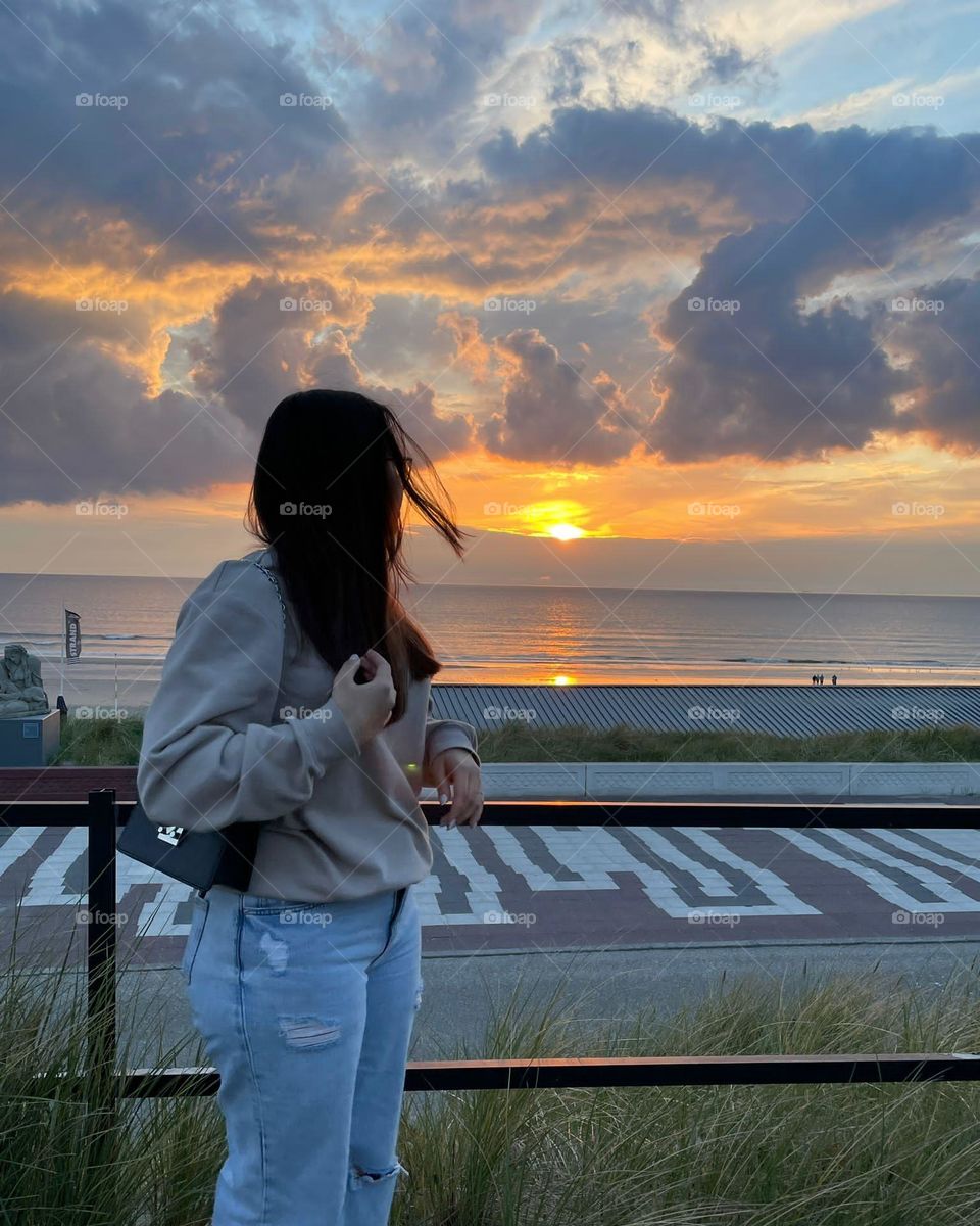Here's me and a extremely beautiful sunset at the zandvoort beach in Holland.