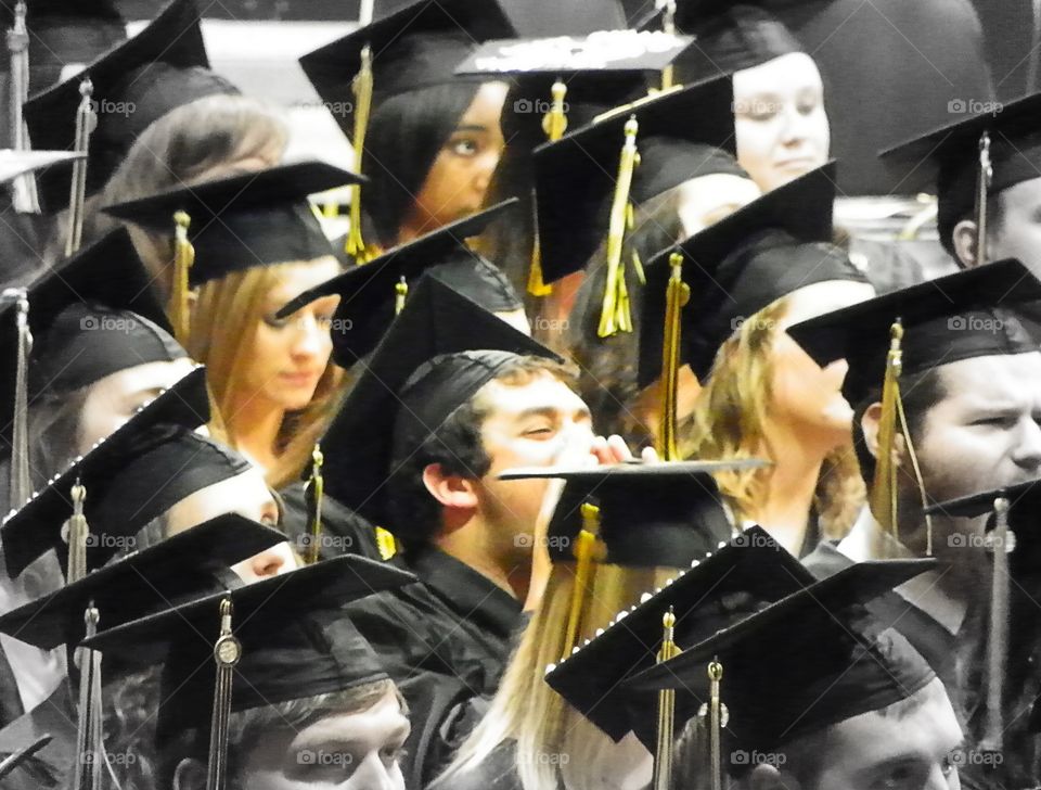 Close-up of graduated students wearing graduation hat