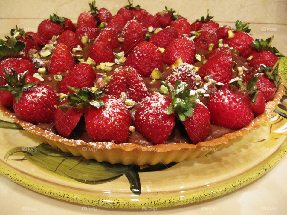 Strawberry tart with chocolate pudding and crunch pistachios