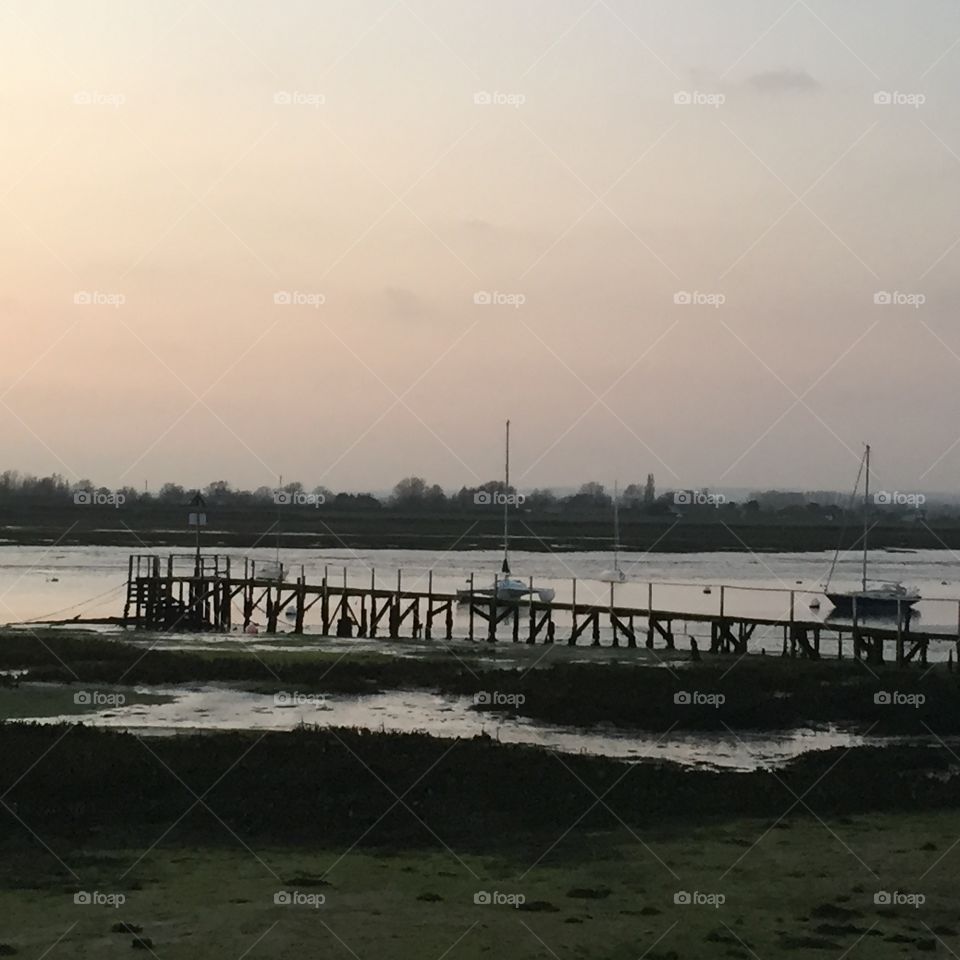 Chichester Harbour at dusk . Jetty 