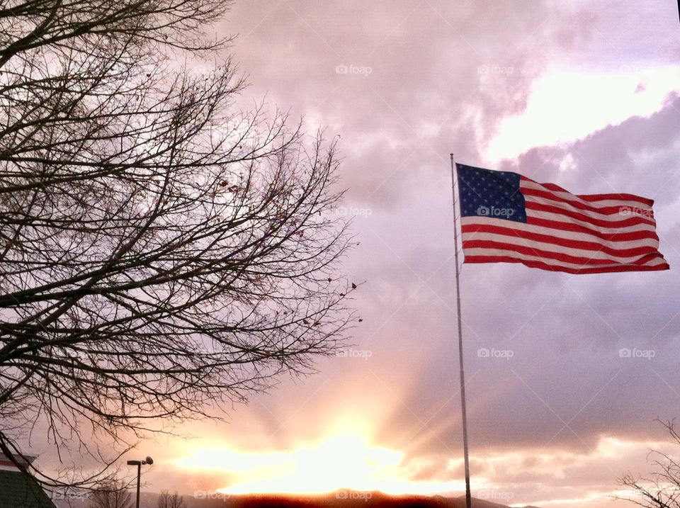 The sun coming through the clouds was a miraculous backdrop for the American flag flying in the wind.