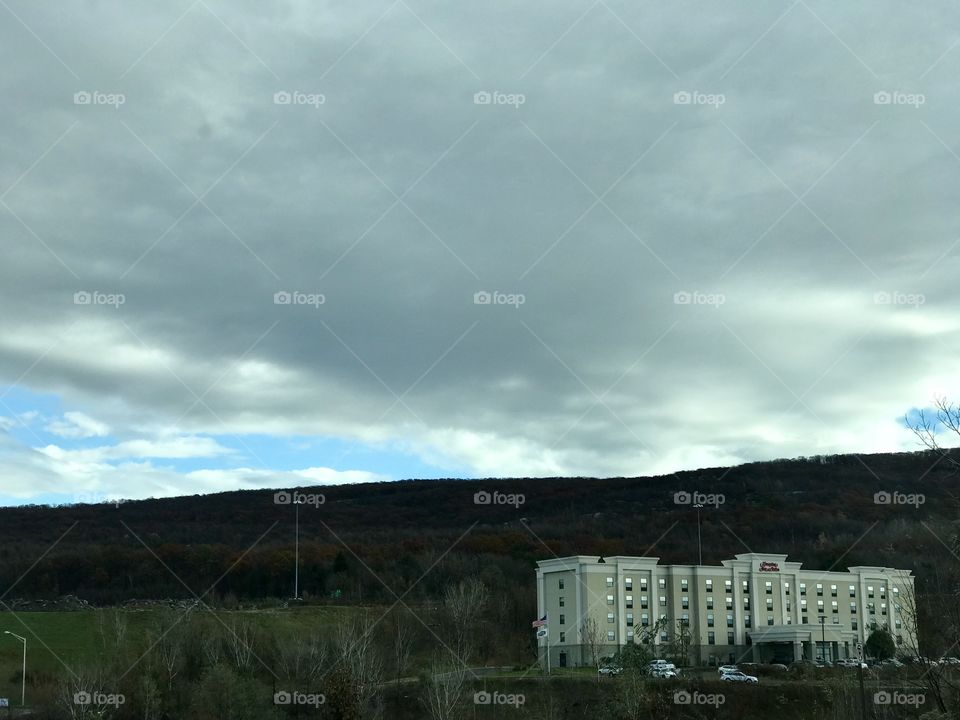Large.white building on the side of a mountain in wintertime 