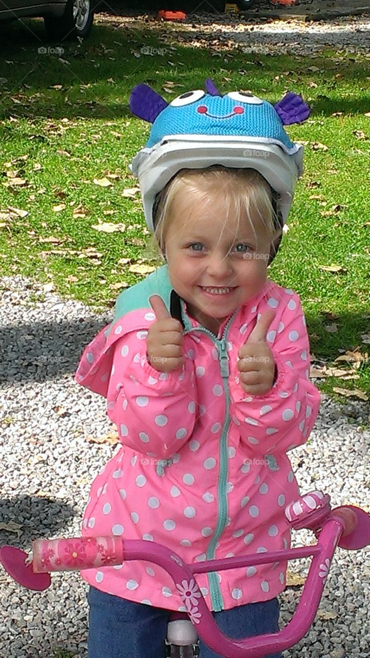 Thumbs Up. Ready to try out her new bike