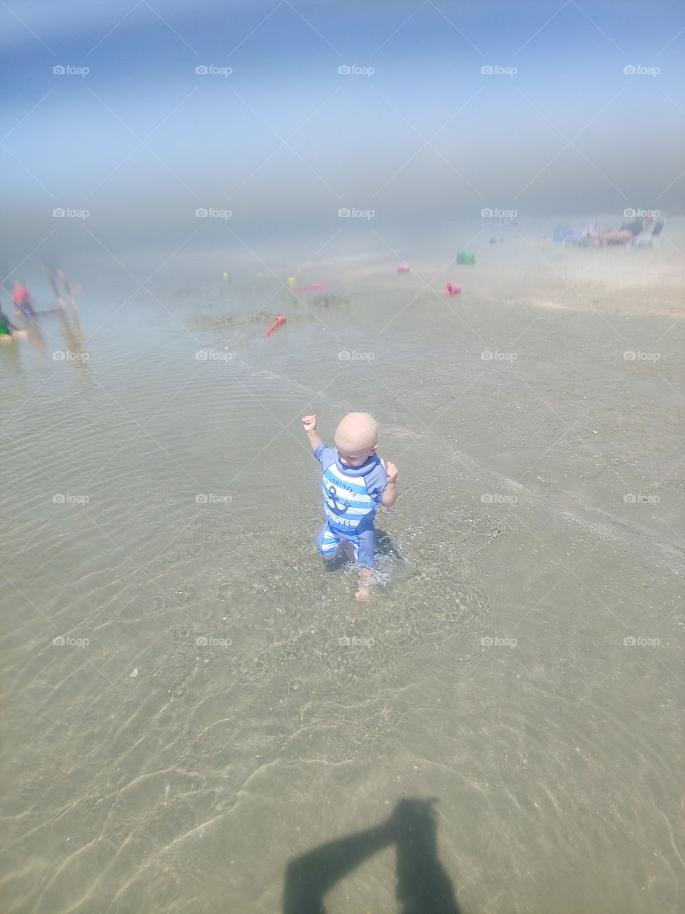 Toddler playing in tidal pool at the beach