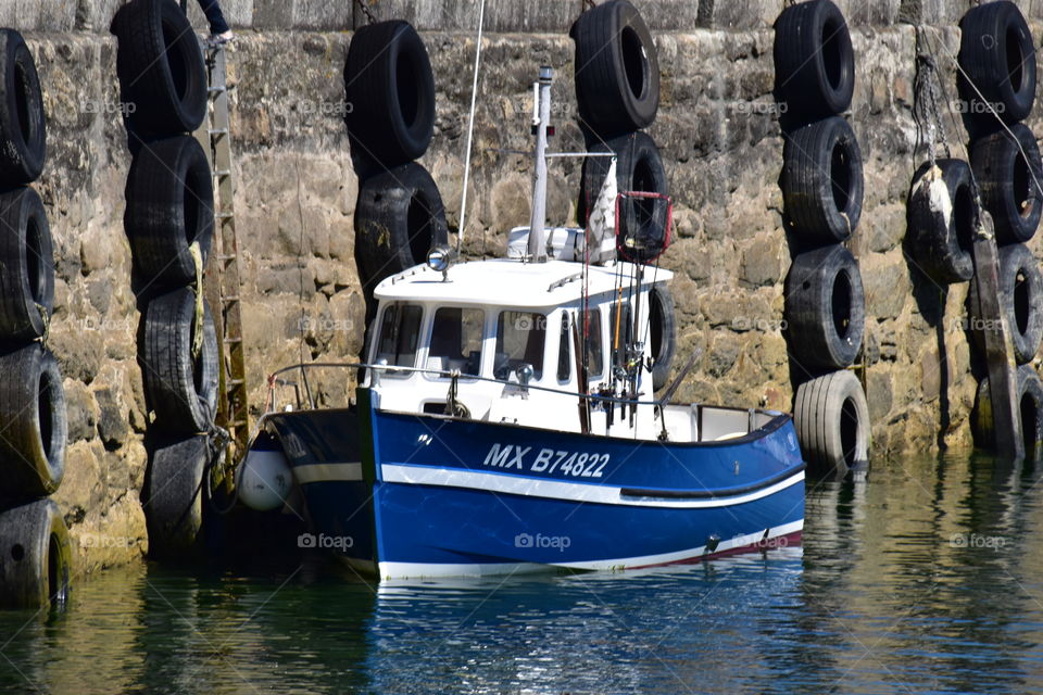 A boat in a Harbour during low tide 