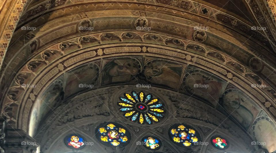 Color flower shape windows in old church in Florence Italy