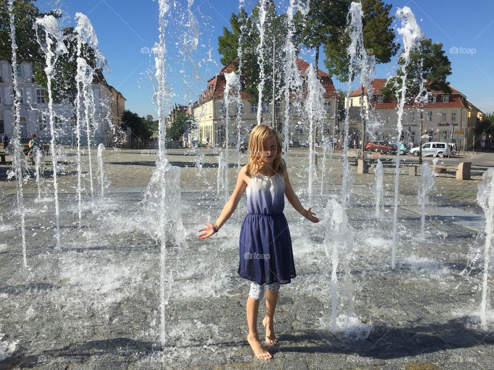 Girl enjoying in fountain