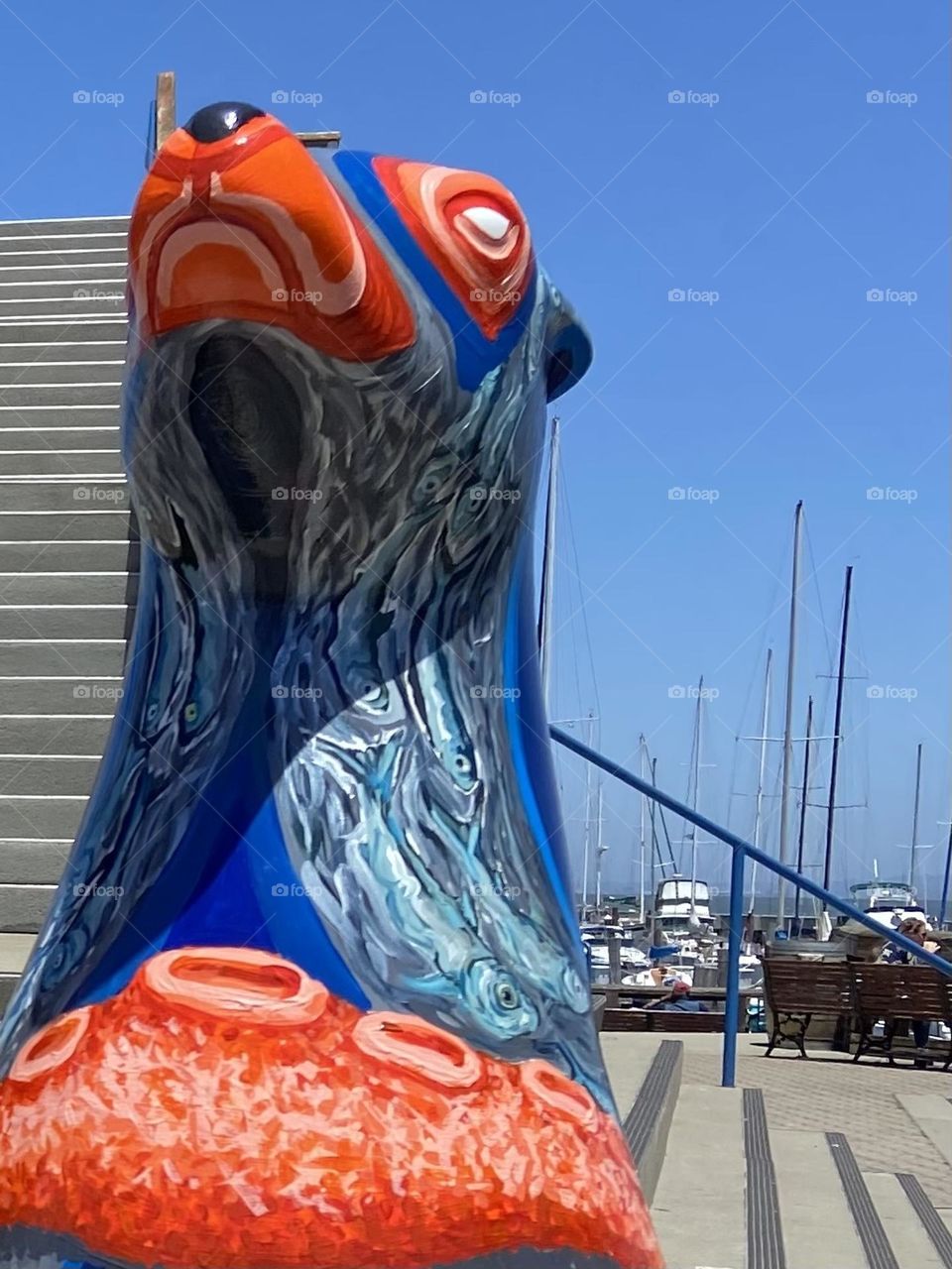 A colorful orange and blue ceramic seal near the harbor in San Francisco.
