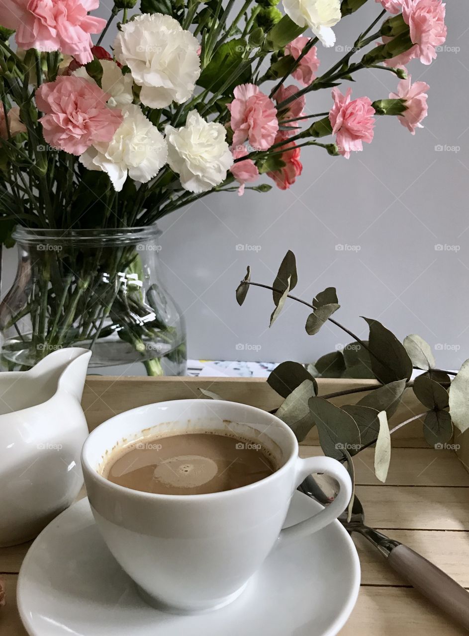 Coffee near flower pot