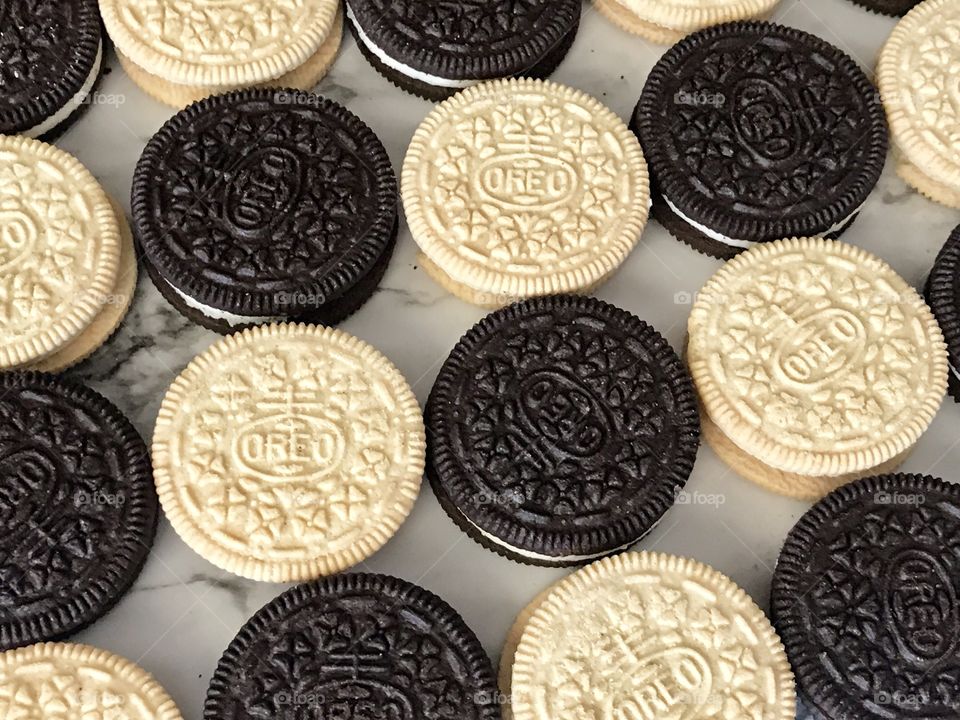 Golden and chocolate Oreo double stuff cookies contrasting Flatlay 