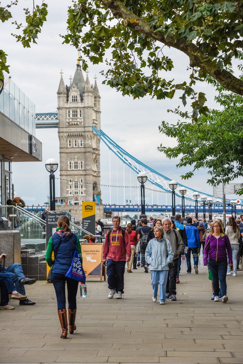 People and tourists nearby Tower bridge in London.