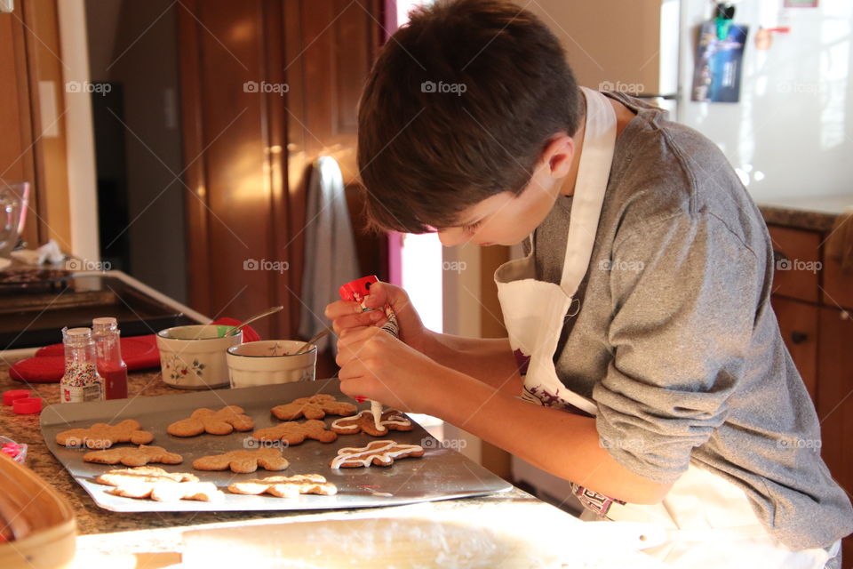 Boy decorating cookies just baked