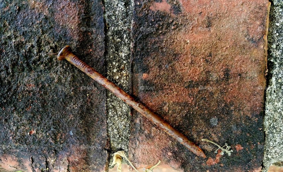 old project.  nail rusting on brick.