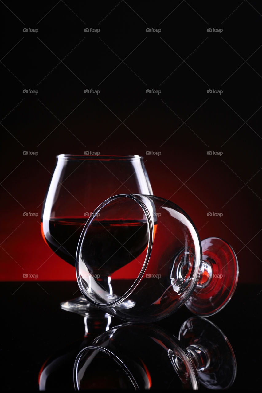 Two red wine glasses creative shot with red background
