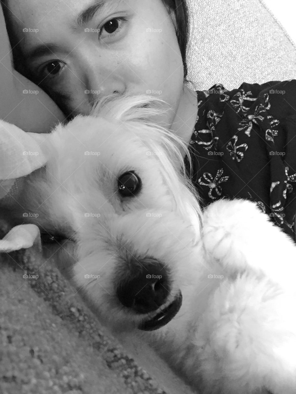Snugly Leo . This is me and my pup . His name is Leo . He is a Coton de tulear . 
