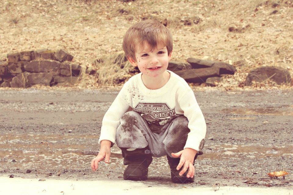 Mud. Toddler splashing in puddles
