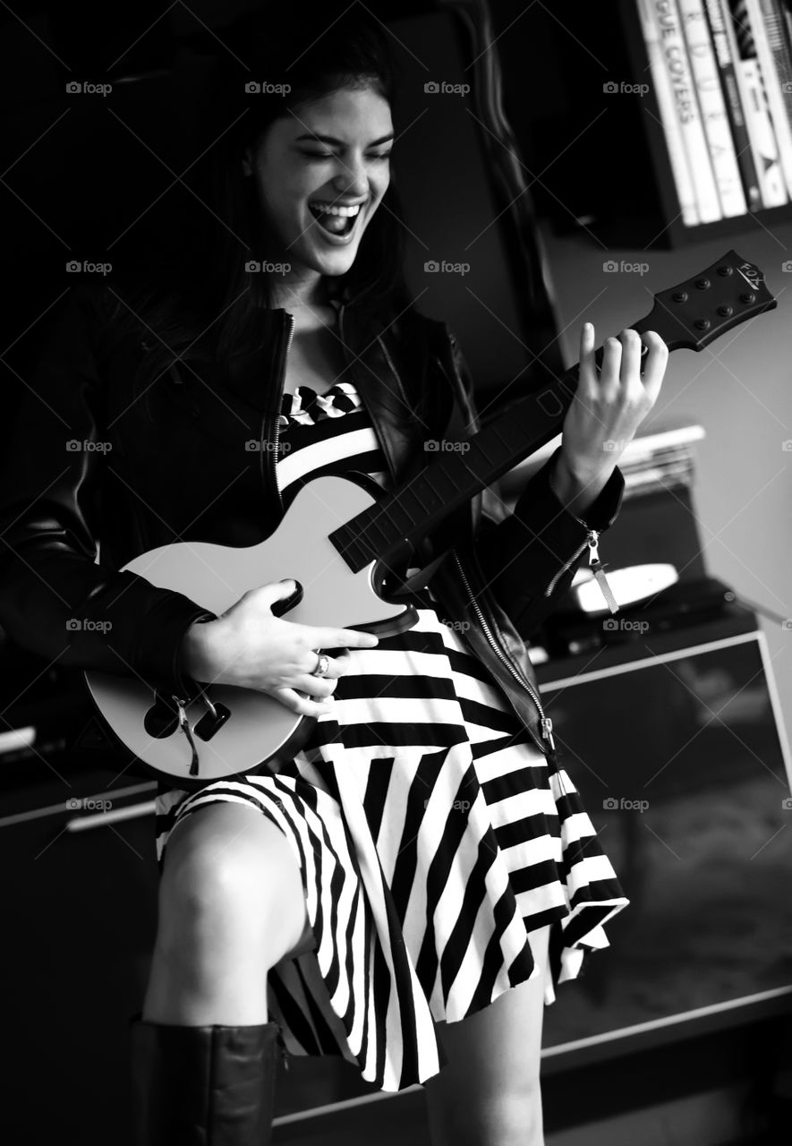 Woman plays fake guitar