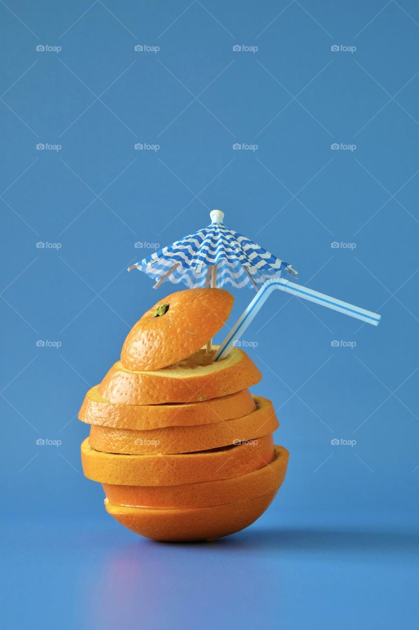 Close-up of sliced orange isolated on blue background. 