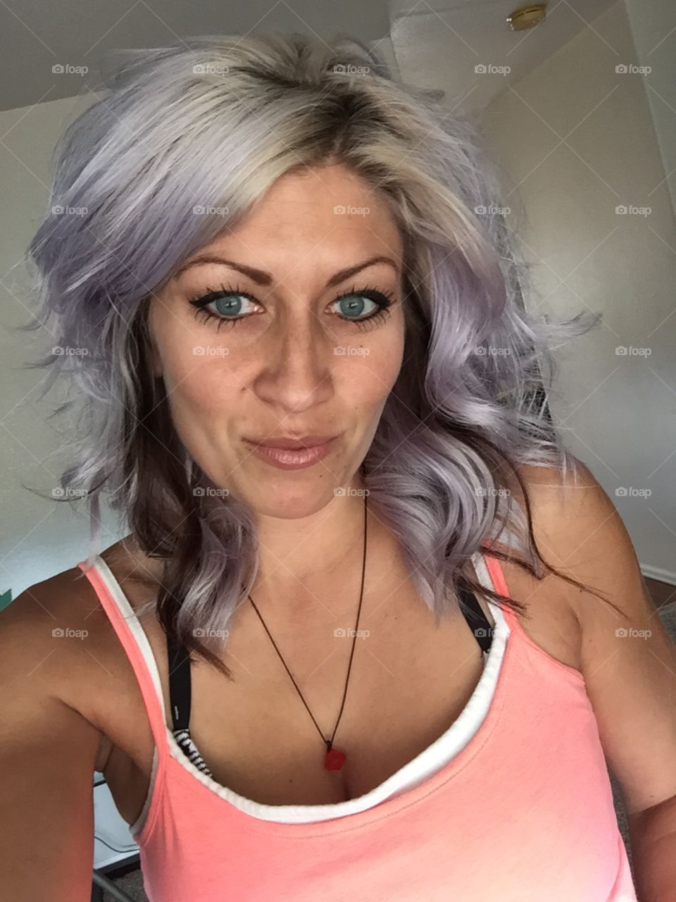 A fun blast of grey hair complimented with an almost black violet peekaboo low lights!