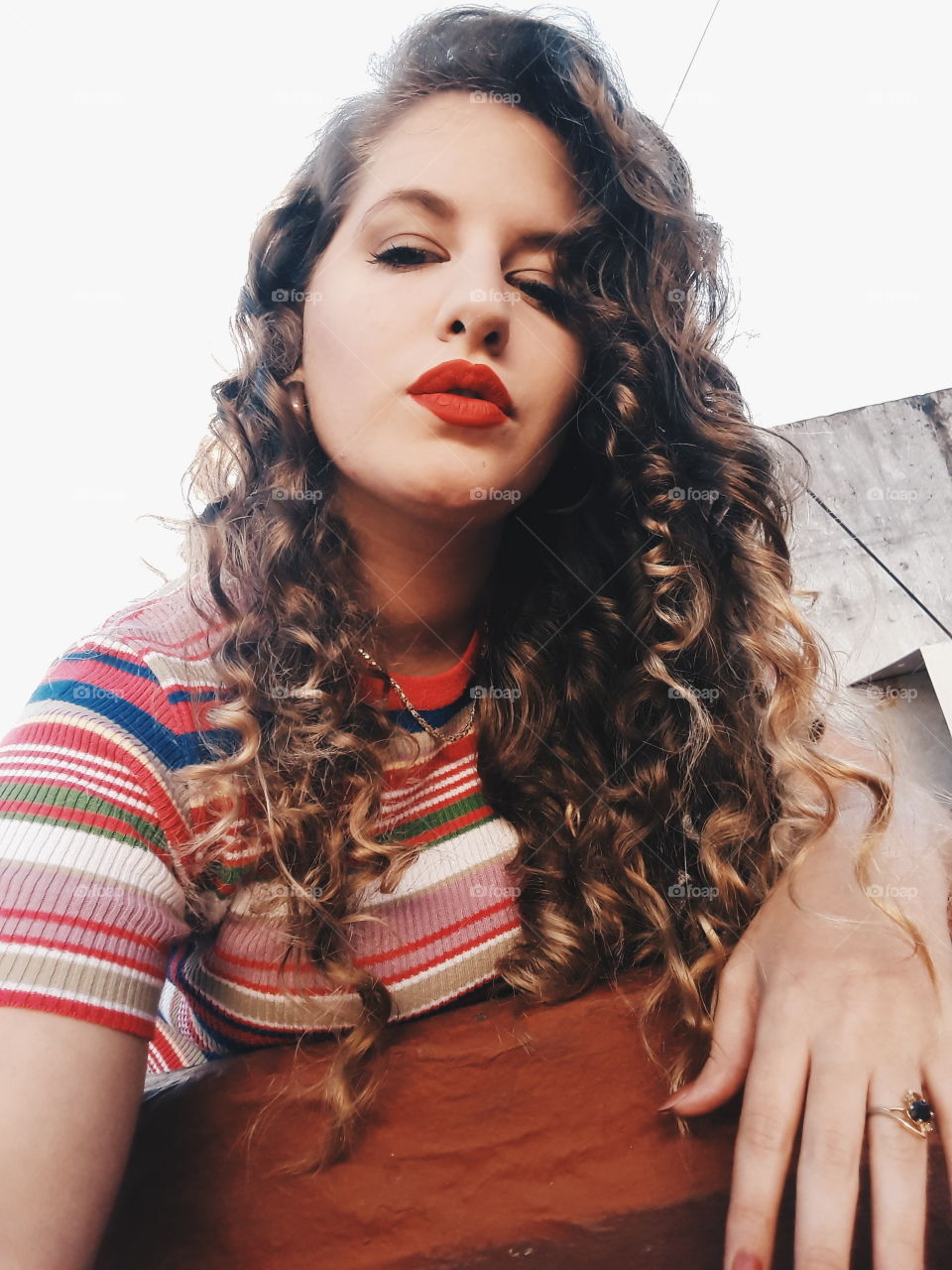 Young woman with curly hair and red lips