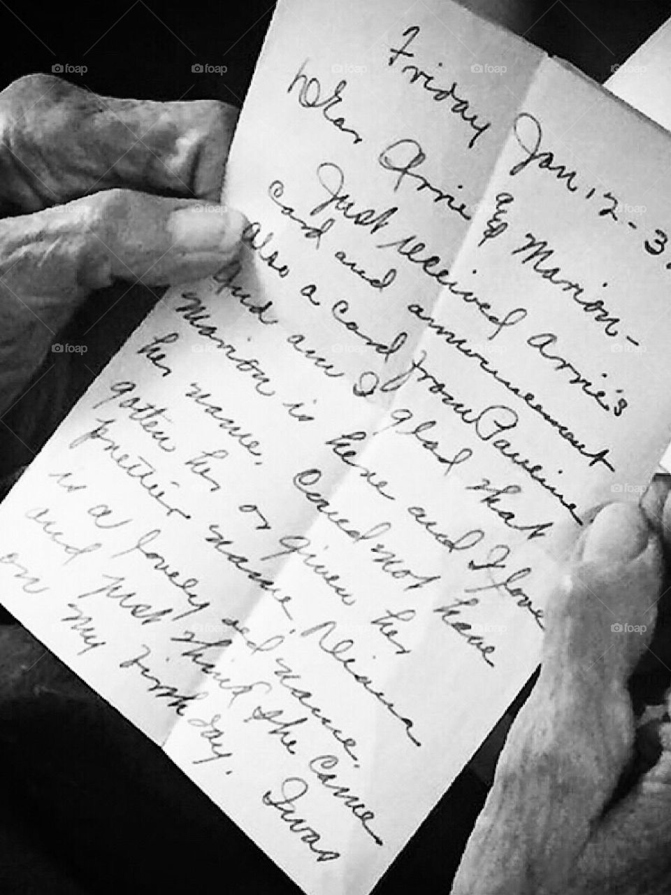 Hands of an elderly woman holding a letter from the past