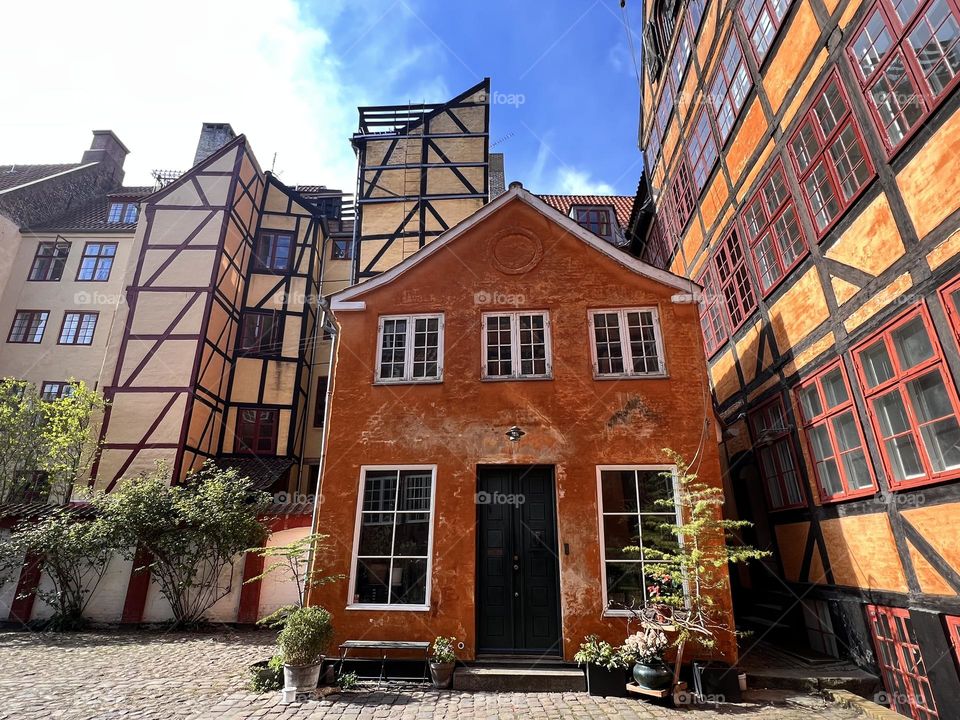 Facades in warm colors in a backyard of the streets in Copenhagen 