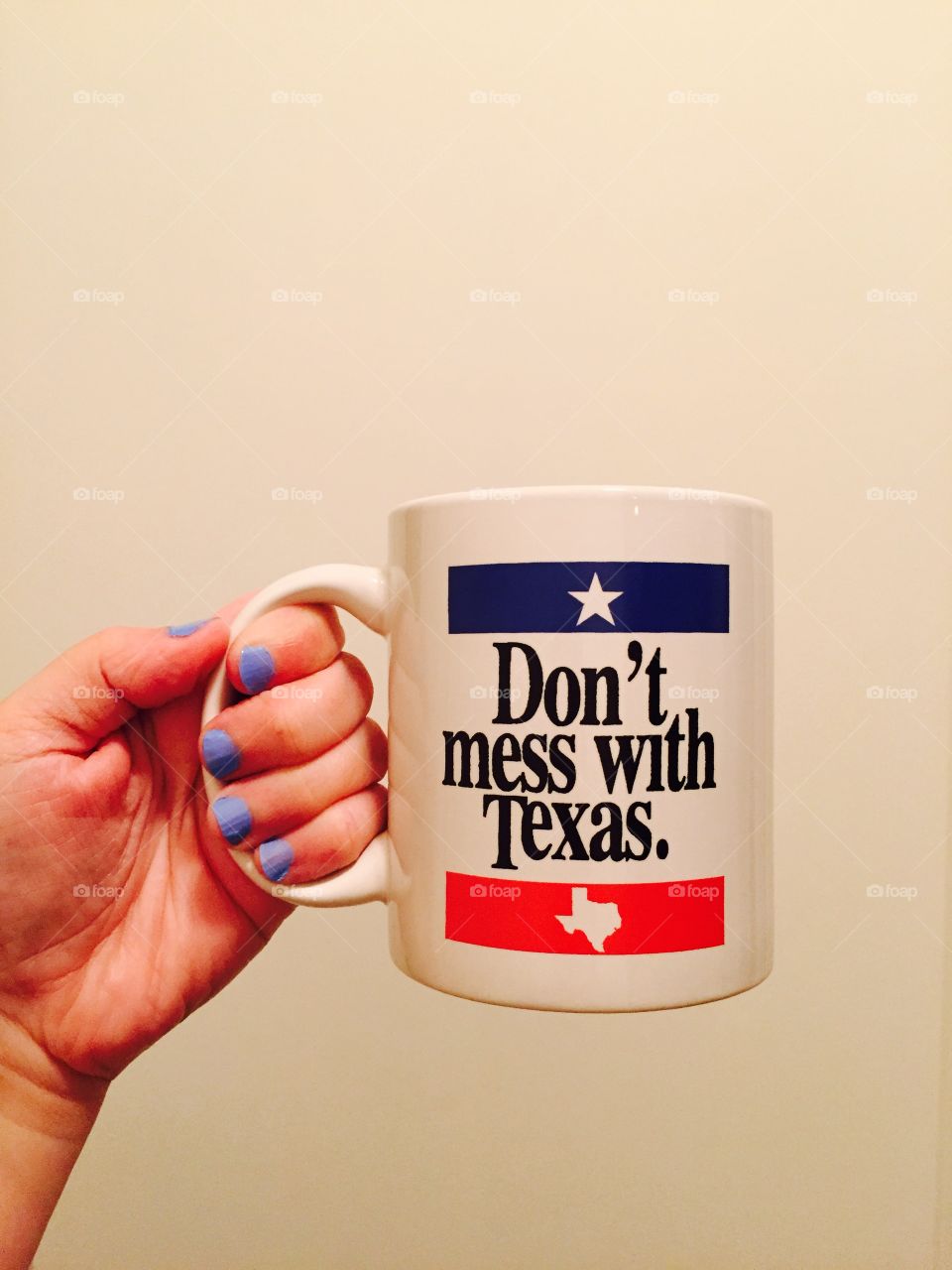 Hand holding Coffee Mug. Don't mess with Texas coffee mug 