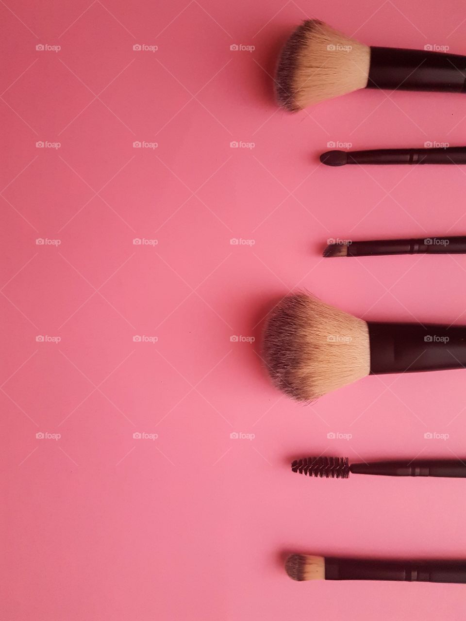 Make up brush on pink background