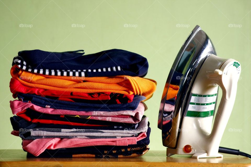 folded shirts or clothes and an iron