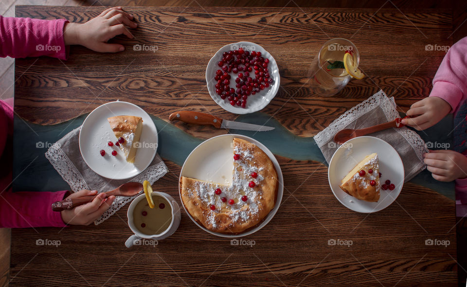 Children breakfast with cheesecake. Hands, detail