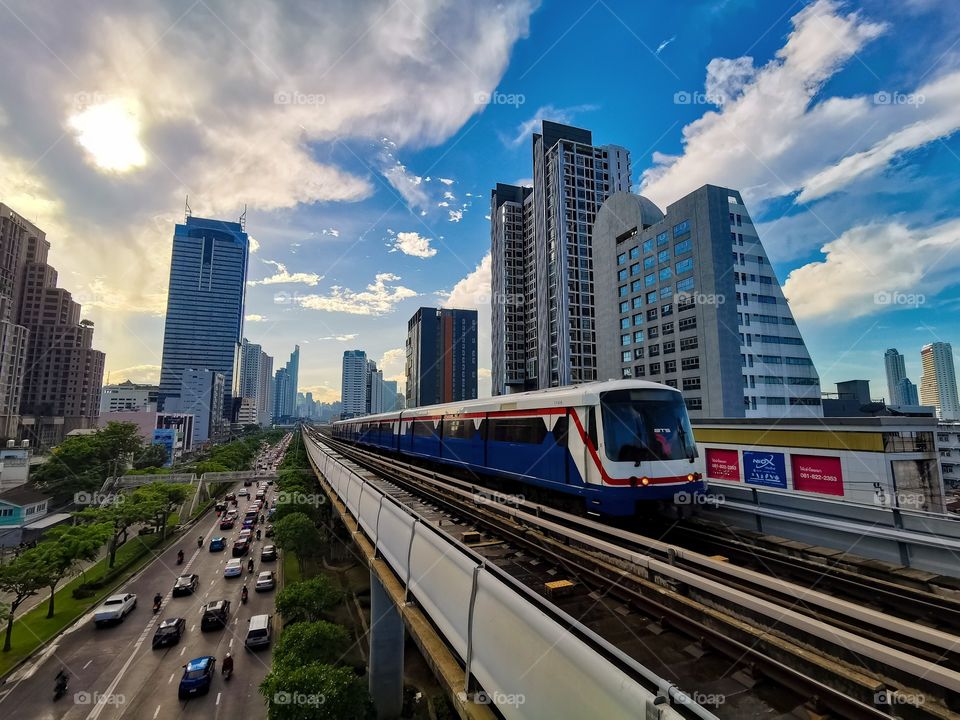 A morning look down Sathorn Road with the BTS sky train pulling in to the station.