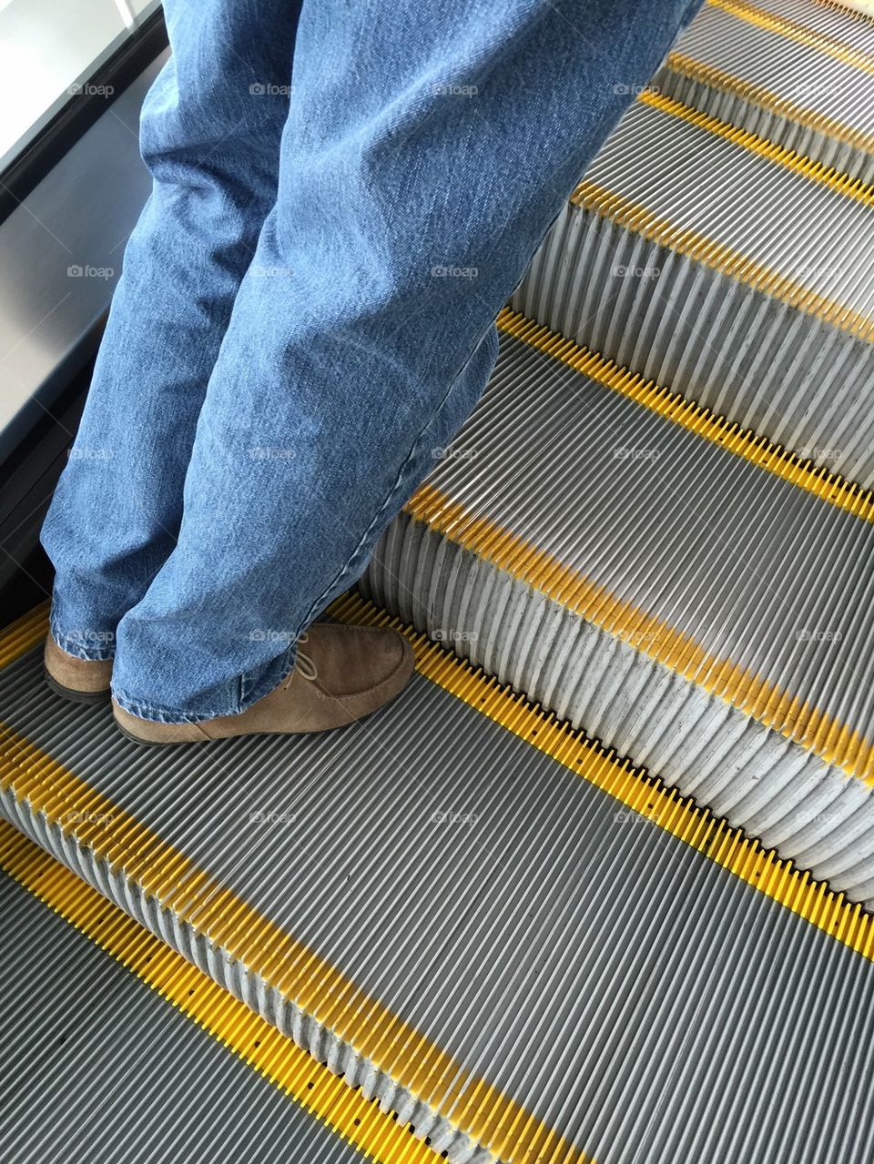 Man going up escalator