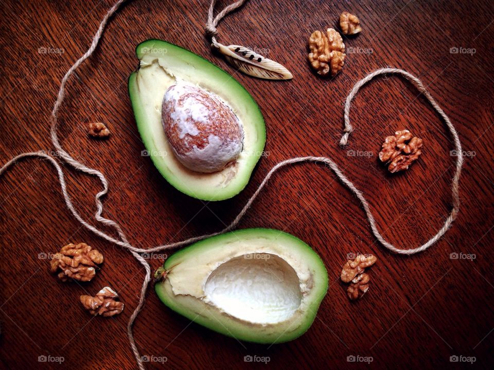 Avocado and nuts on wooden table