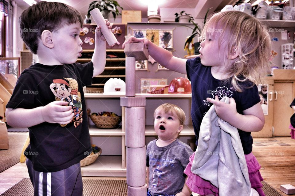 Children stacking wooden block
