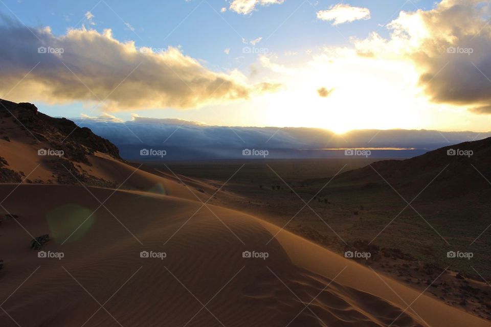 Sun rising over the sand dunes