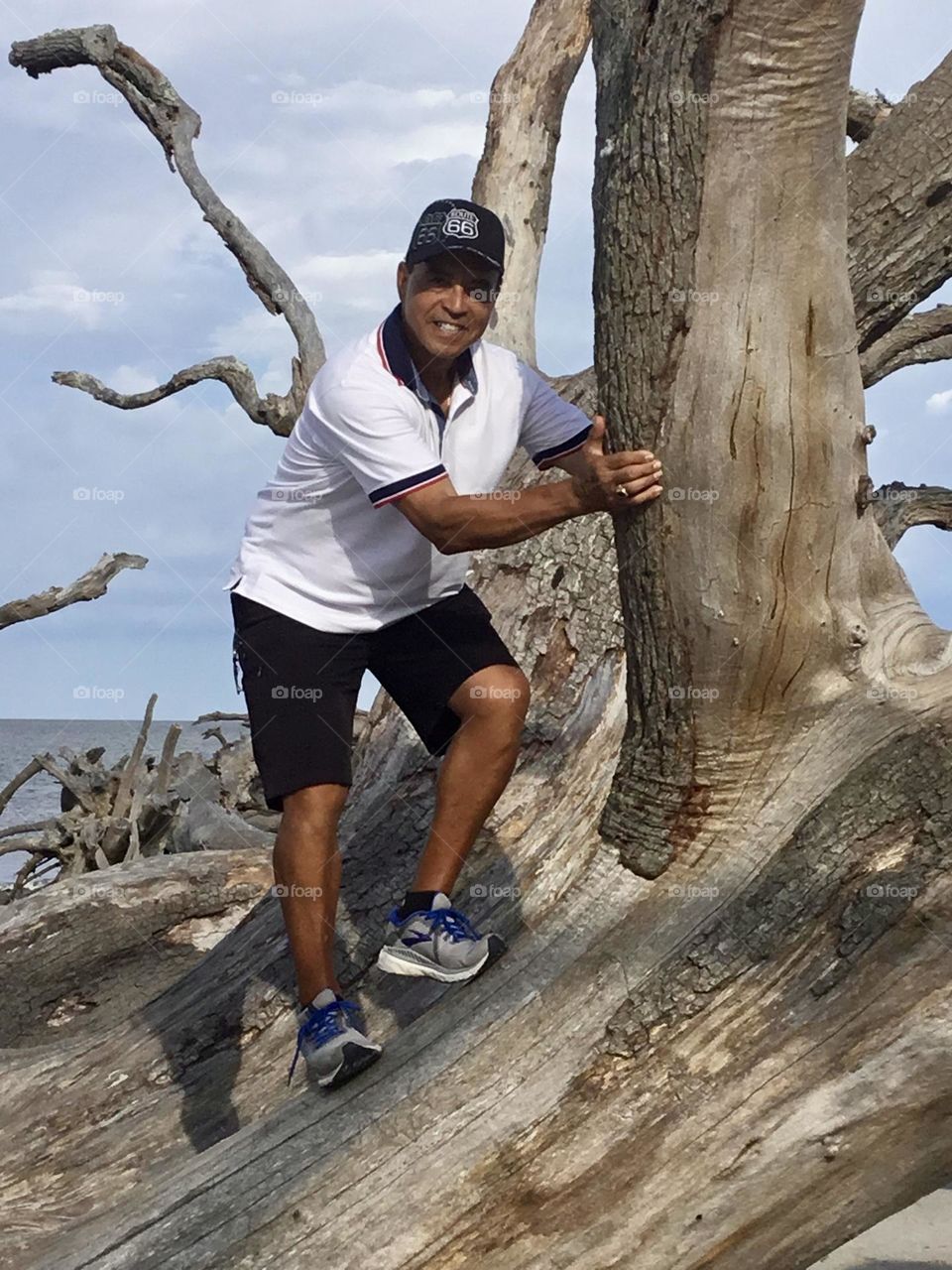 Father’s Day Tribute: Honoring Fathers Everywhere - Enjoying Father’s Day by climbing on a driftwood tree during a photo op. 