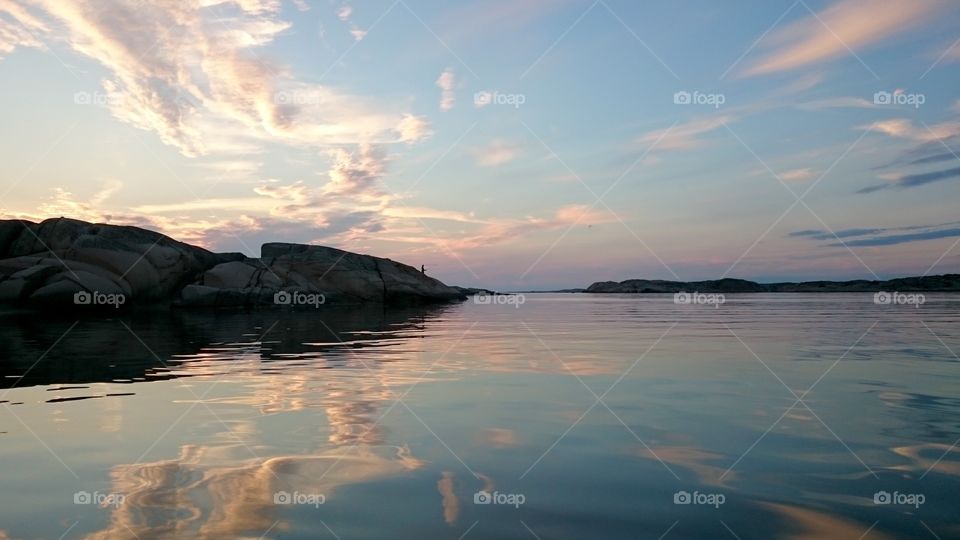 Fisherman on the cliff in sunset