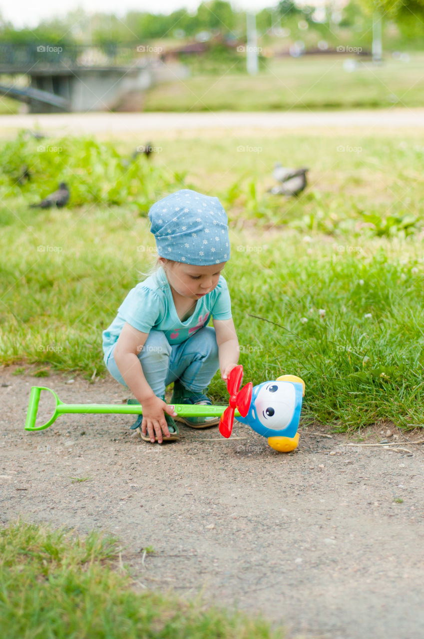 Little girl plays outdoors 